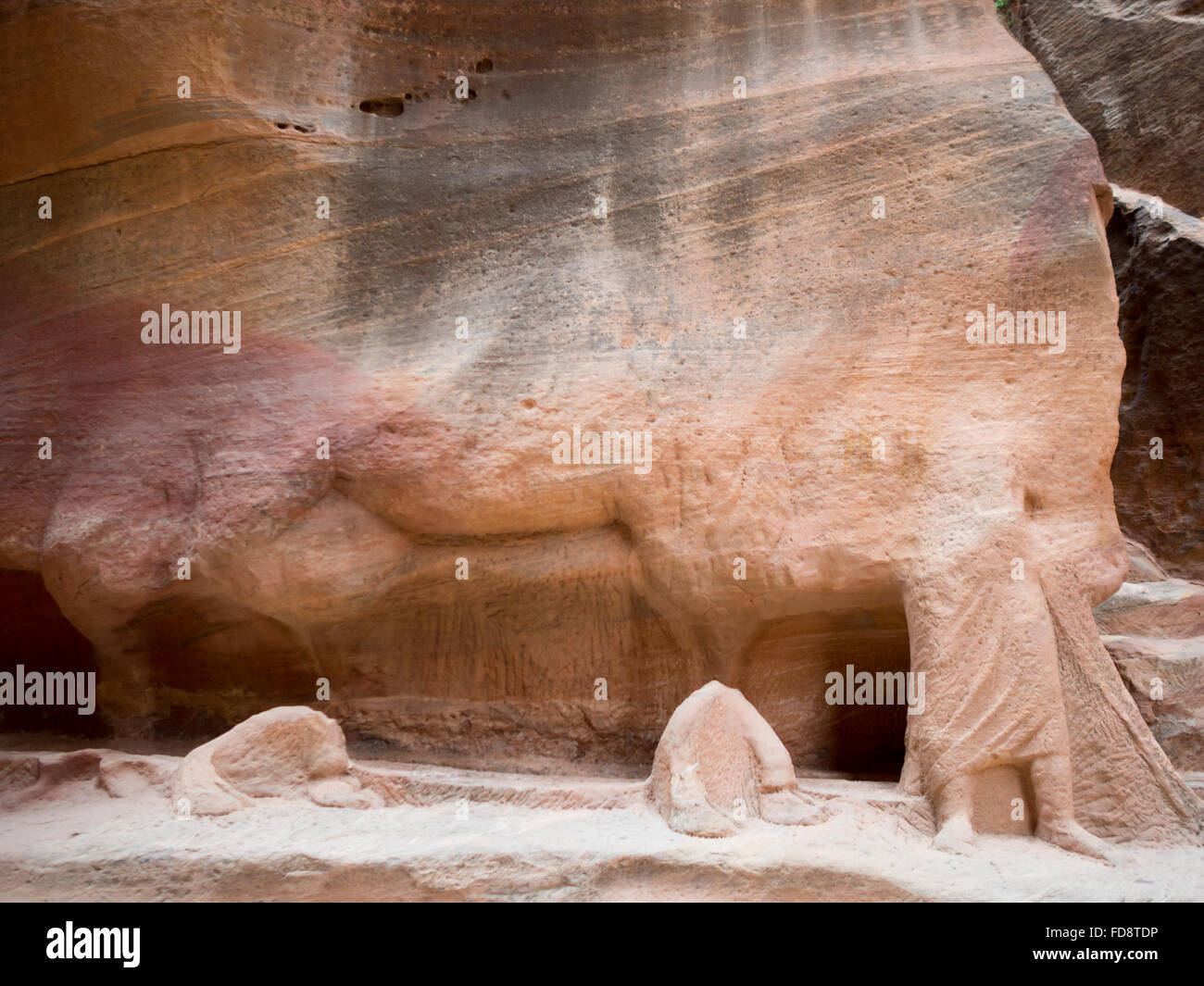 Man feet and camel toes carved into the stone in Petra Siq Stock Photo