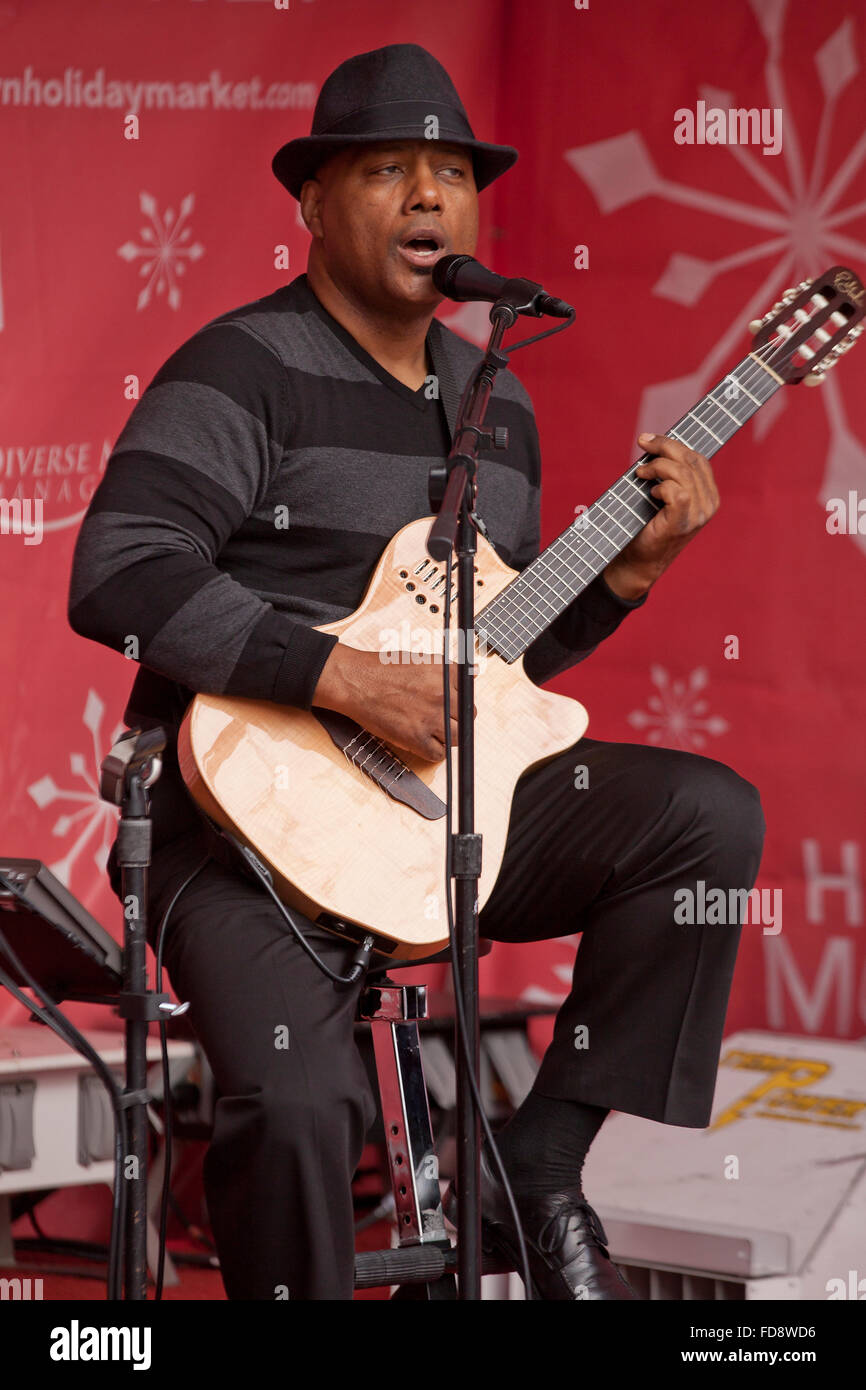 Singer, guitar player performing on stage - USA Stock Photo