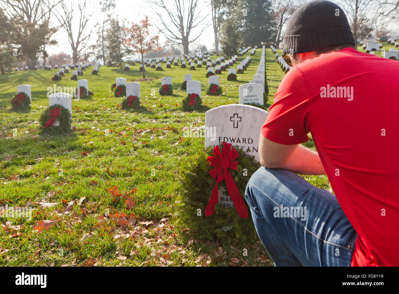 Man laying Christmas wreath at Arlington National Cemetery Washington