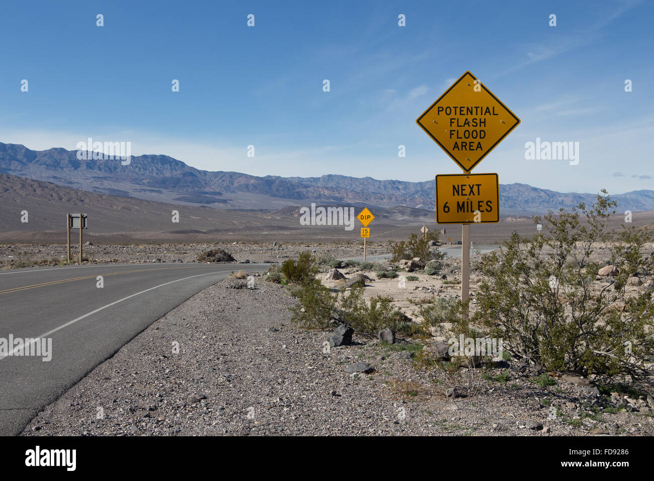 Flash flood warning signs aon the roadside in Death Valley California warning visitors of potential flooding danger Stock Photo