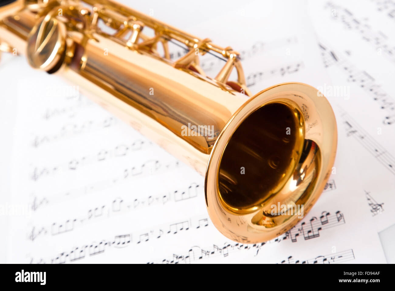 Musical notes and saxophone, isolated on white Stock Photo