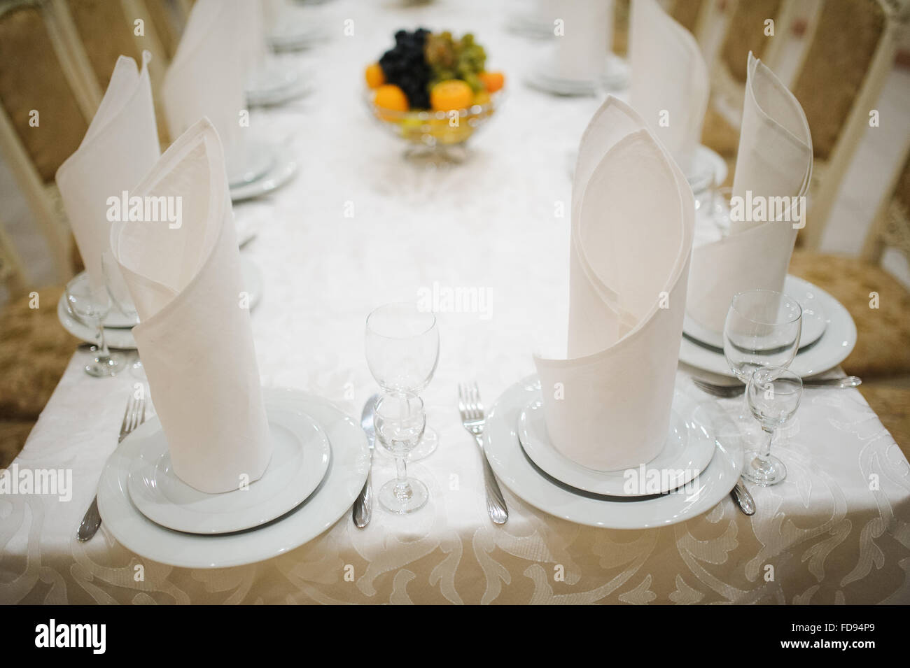 Banquet wedding table setting with plate, spoon, fork and knife Stock
