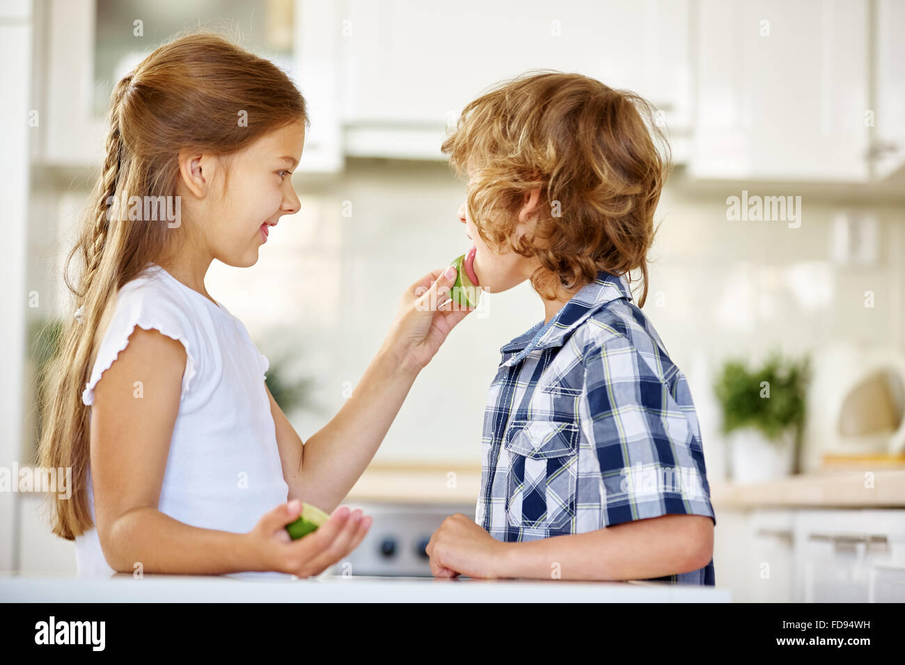 girl-daring-boy-to-lick-on-a-lime-fruit-in-the-kitchen-stock-photo-alamy
