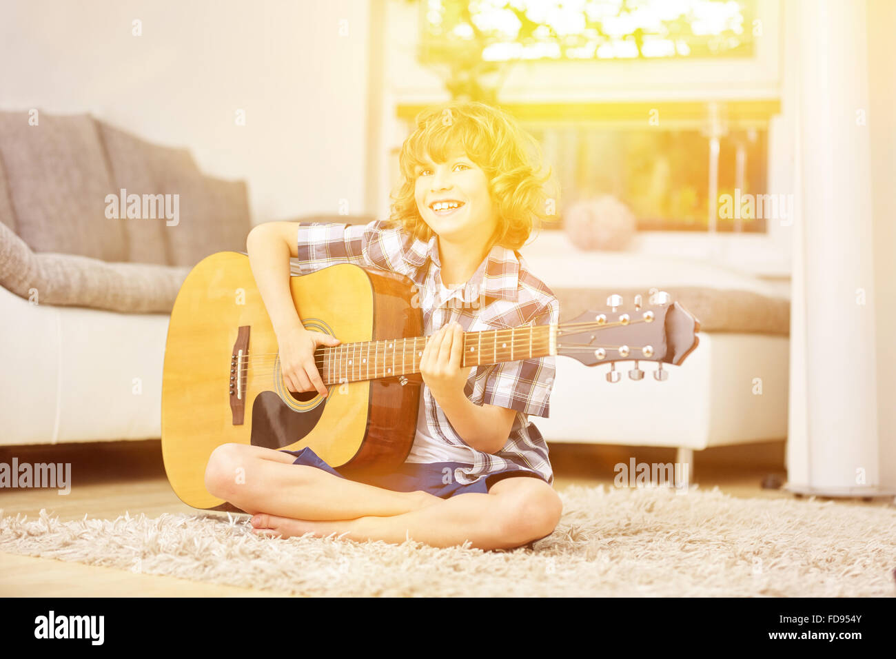 Happy boy singing and playing music with guitar Stock Photo - Alamy