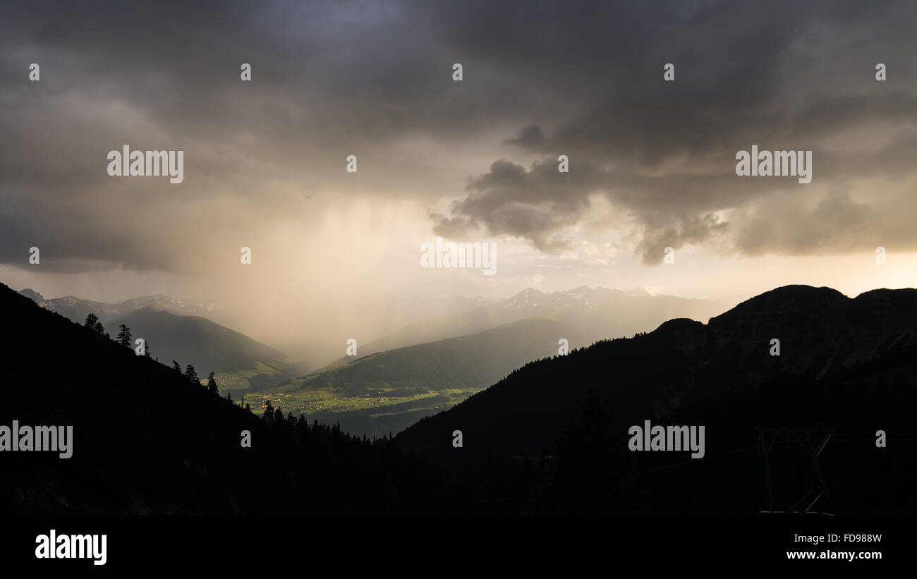 Thunderstorm over Sellrain valley in the Austrian alps illuminated by the sunset viewed from the Solsteinhaus mountain hut Stock Photo
