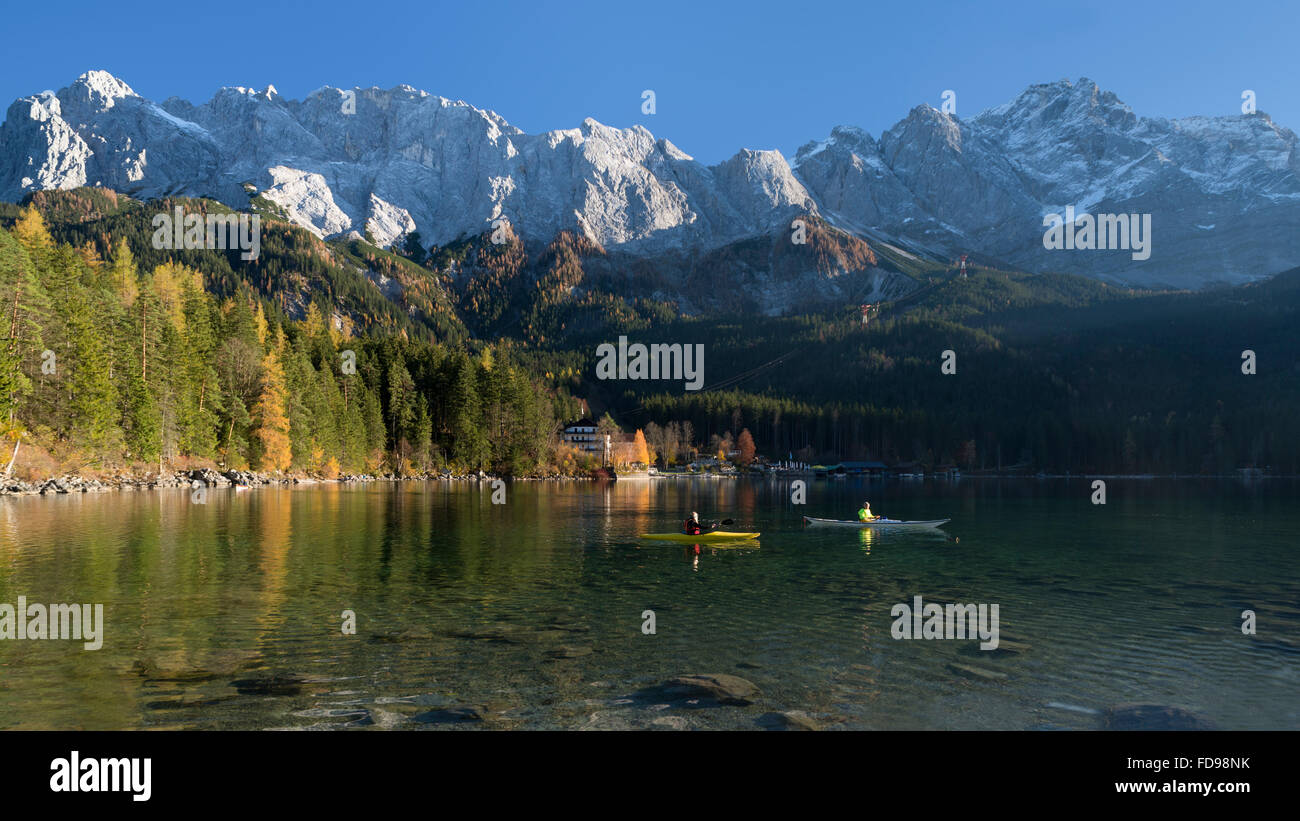 Autumn scenery with kayakers on lake Eibsee in front of Wetterstein mountain range with Mount Zugspitze,Bavaria,Germany Stock Photo