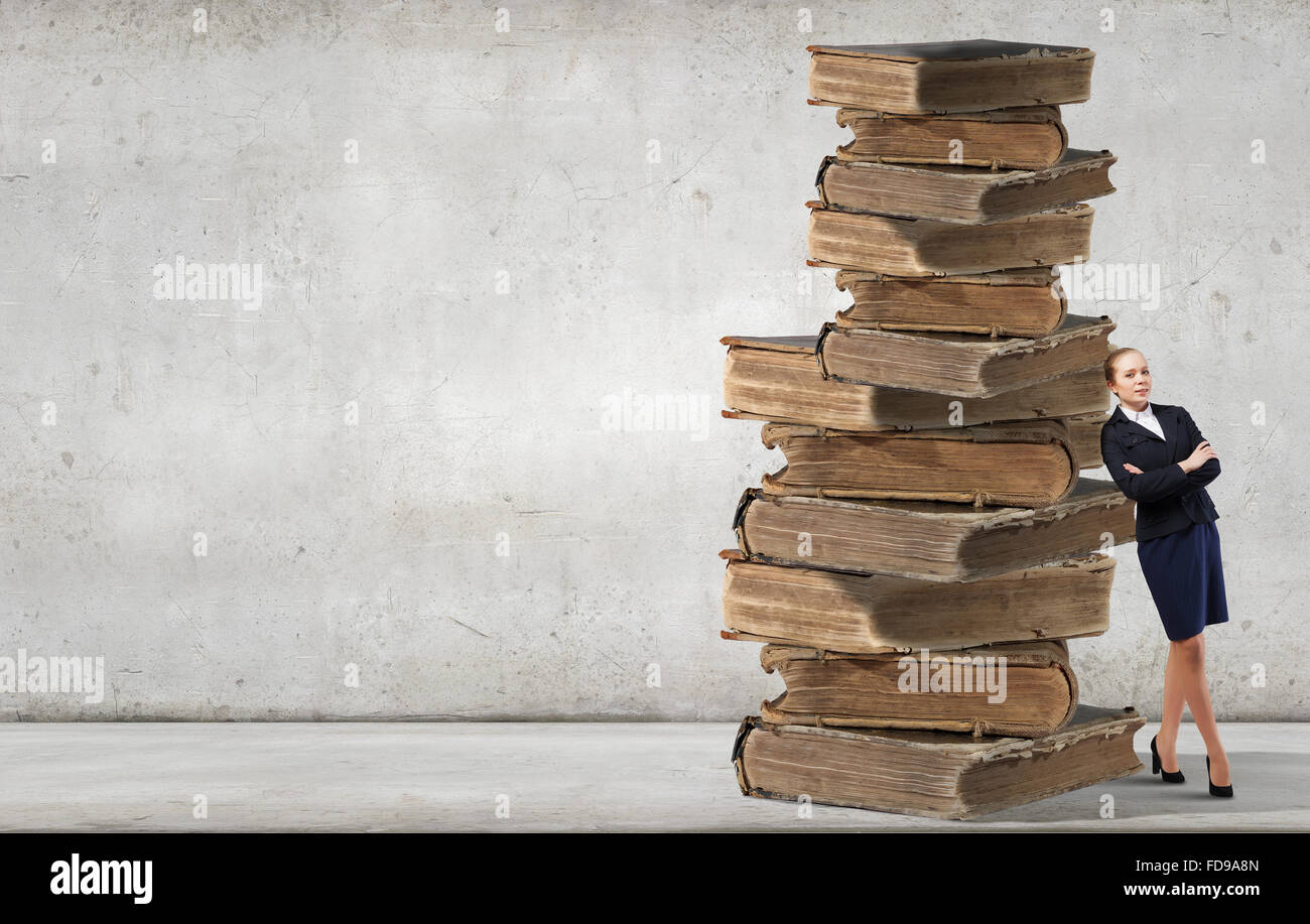Young woman and huge pile of old books Stock Photo - Alamy