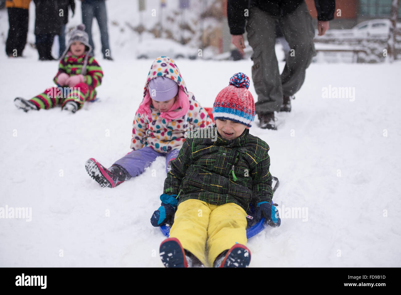 group of kids having fun and play together in fresh snow on winter ...