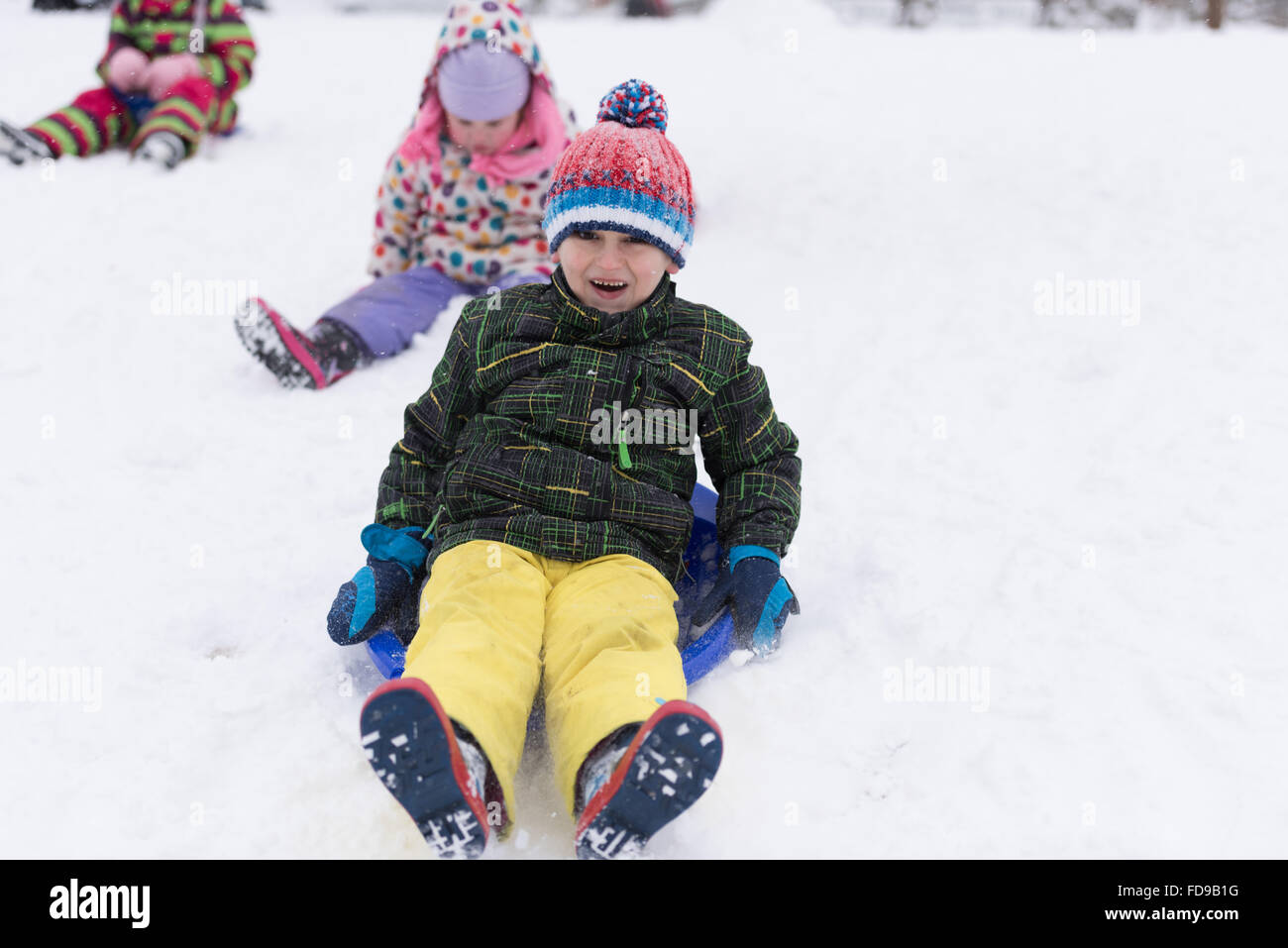 group of kids having fun and play together in fresh snow on winter ...
