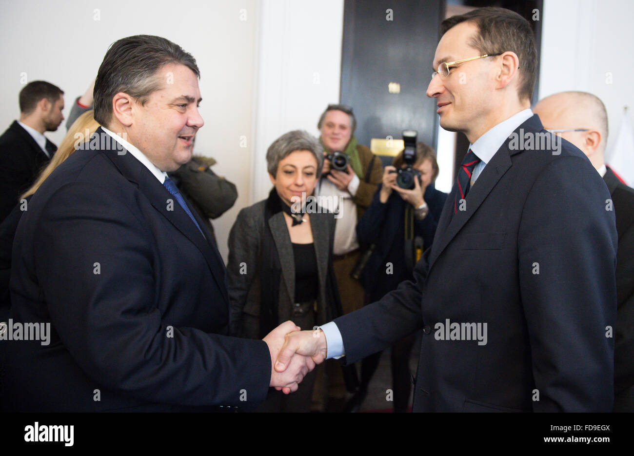 German Minister for Economic Affairfs Sigmar Gabriel (L, SPD) and the vice-Prime Minister of Poland and Minsiter of Economic Development Mateusz Morawiecki shake hands in Warsaw, Poland, 29 January 2016. Gabriel traveled to Poland for talks in Warsaw and Wroc?aw. Photo: Bernd von Jutrczenka/dpa Stock Photo