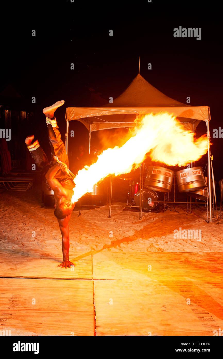 Flame thrower performs on the beach at night, Santa Lucia, Lesser Antilles, Caribbean Stock Photo