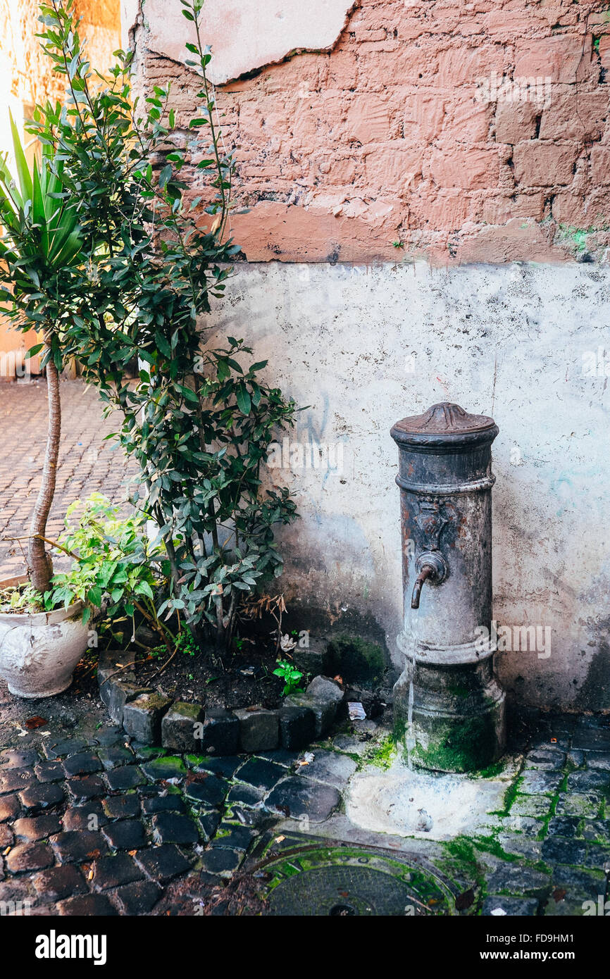 One of the classic Roman water fountains ('Fontanella' or 'Nasone') located throughout the city of Rome, Italy Stock Photo