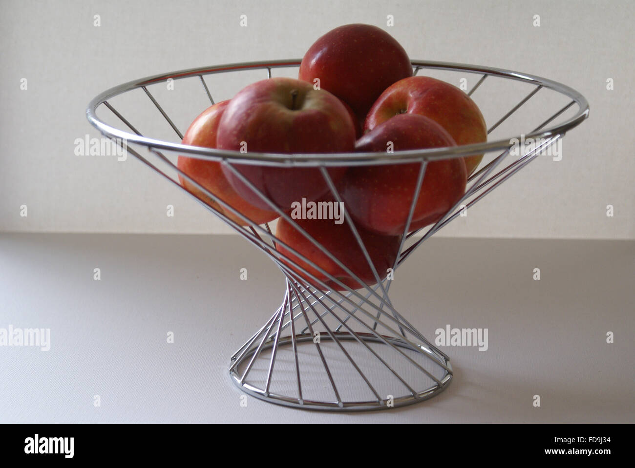 a wire fruit bowl with apples Stock Photo Alamy