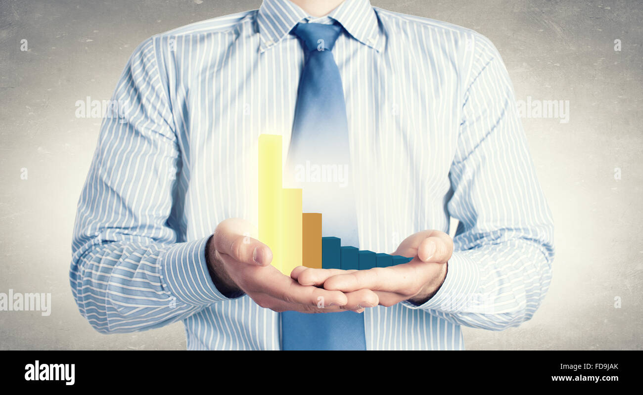 Close up of businessman holding decline graph in palm Stock Photo