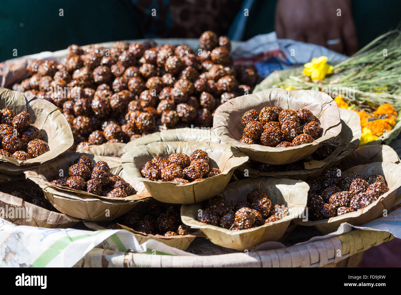 Bowls with saffron water and flowers at Bodhnath stupa in Kathmandu valley, Nepal Stock Photo