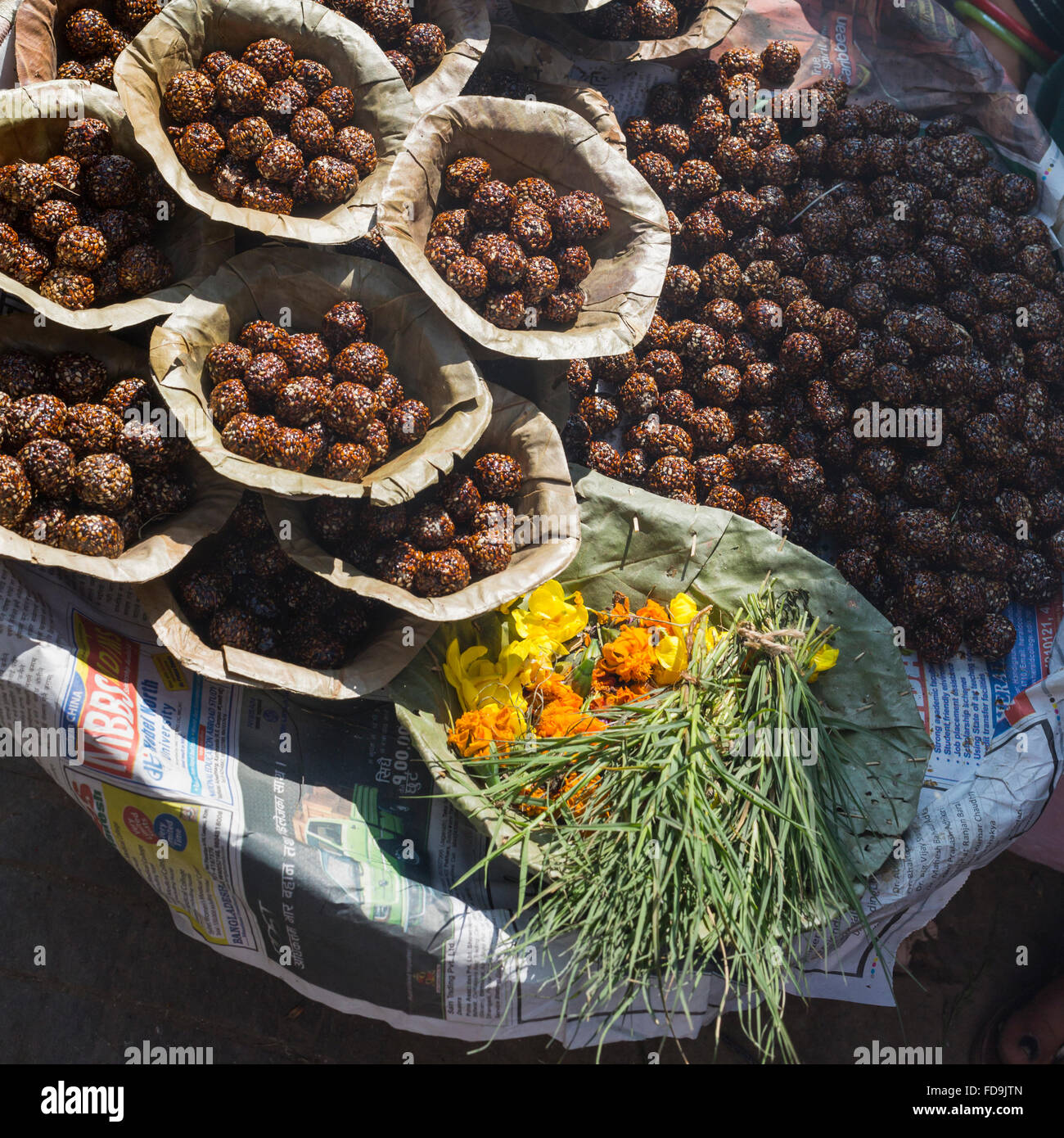 Bowls with saffron water and flowers at Bodhnath stupa in Kathmandu valley, Nepal Stock Photo