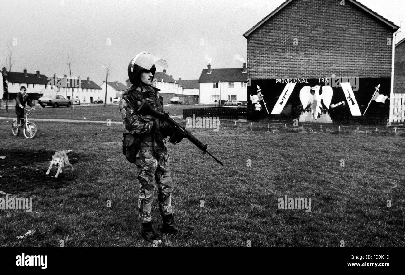 A dog barks at a soldier from The Queens Regiment while patrolling the streets of Belfast , Northern Ireland in April 1984 . Nearly 2000 soldiers from the regiment with over 200 from Sussex were stationed in Ireland at the time Stock Photo