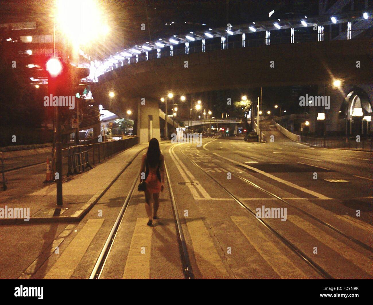 Woman walking along street hi-res stock photography and images - Alamy