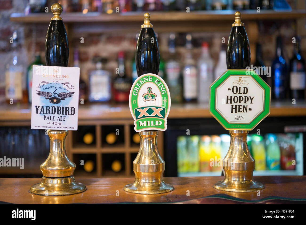 Beer handpumps in the interior of a traditional English pub Stock Photo