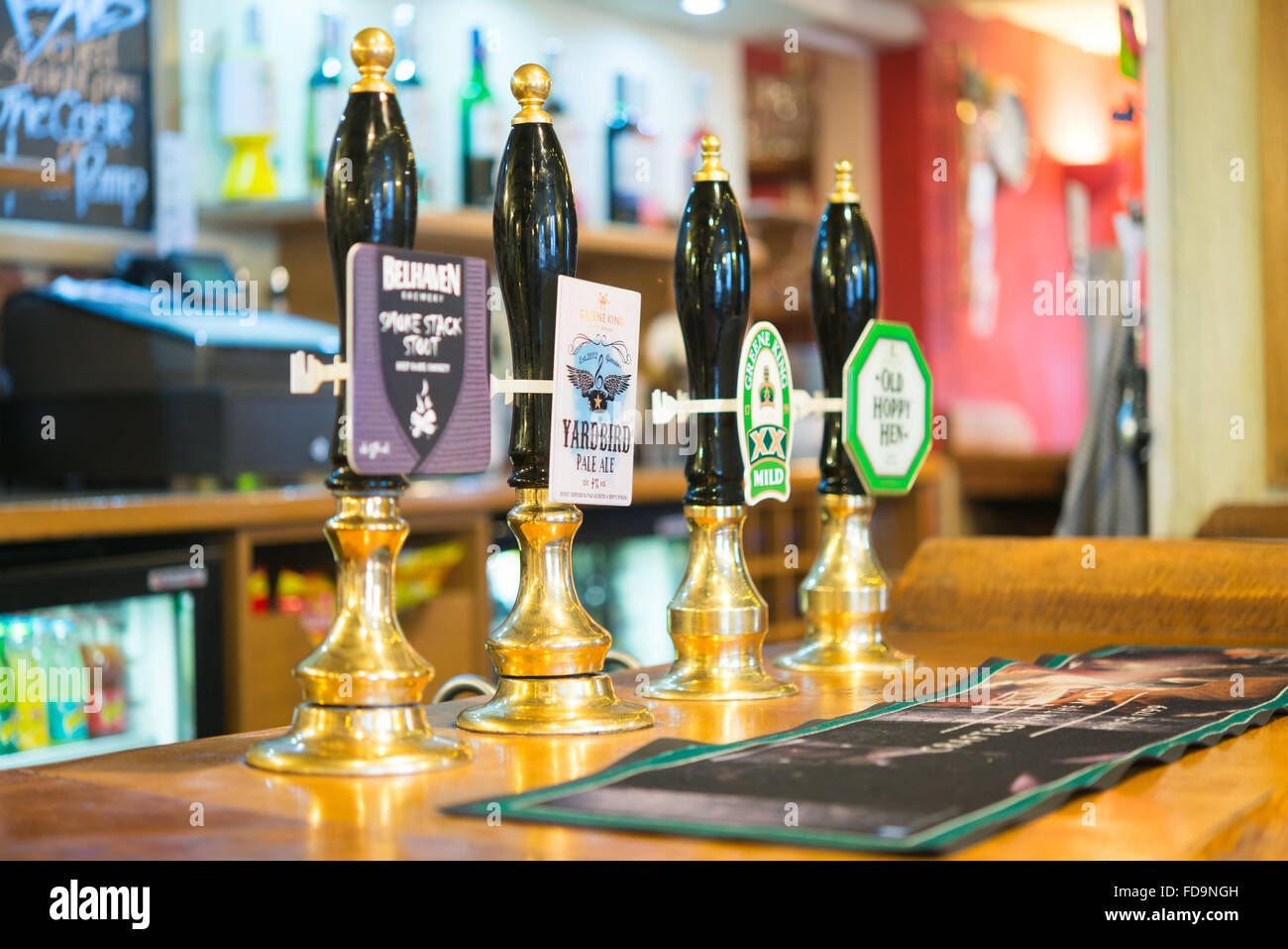 Beer handpumps in the interior of a traditional English pub Stock Photo