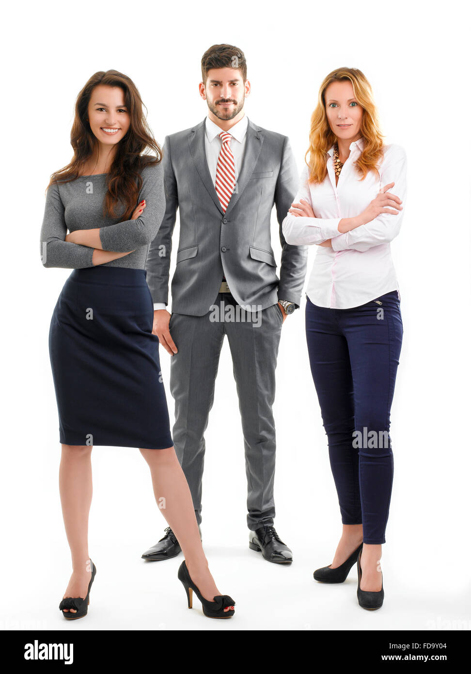Full length portrait of successful sales team standing against white background. Stock Photo