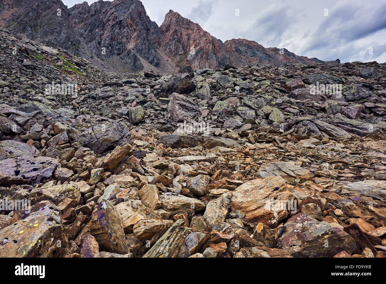 Brown pieces of layered rocks riegel moraine bolt in the mountains . Sayan mountains . Russia Stock Photo