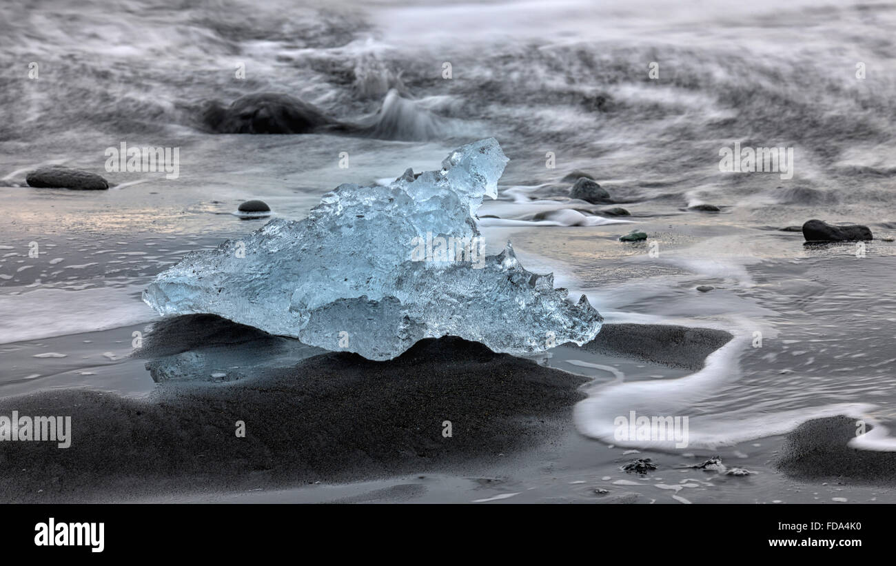 Stranded Iceberg beside the lava of Breidasandur, Southern Region, Iceland Stock Photo
