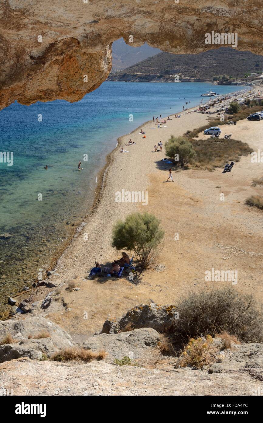 Overview of Petra beach from an eroded tunnel through a large volcanic rock above the beach, named 'Kalikatsou', Patmos, Dodecan Stock Photo