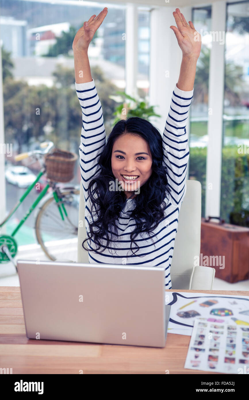 Happy Asian woman with arms raised Stock Photo - Alamy