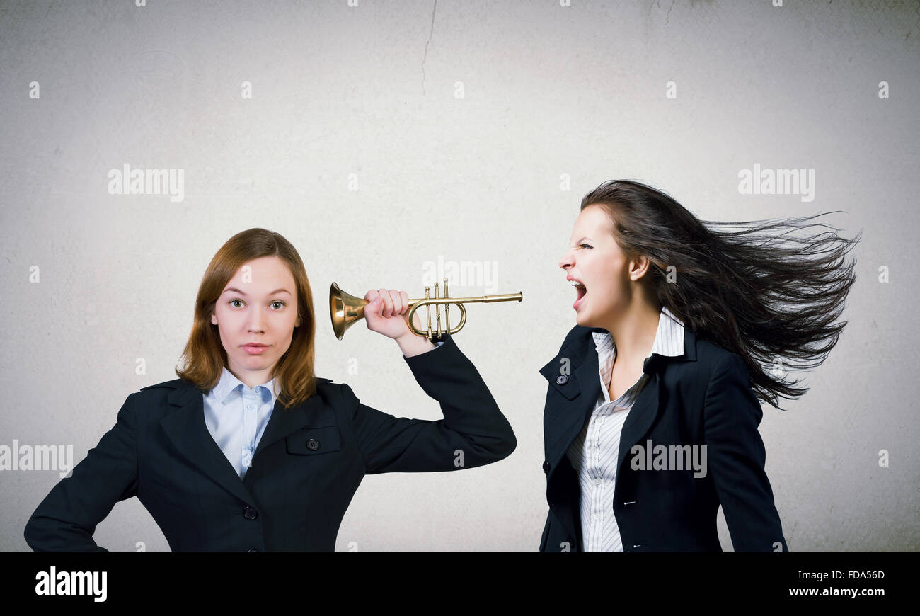 Businesswoman scream agressively in horn at another woman Stock Photo