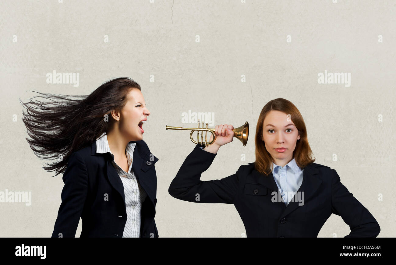Businesswoman scream agressively in horn at another woman Stock Photo