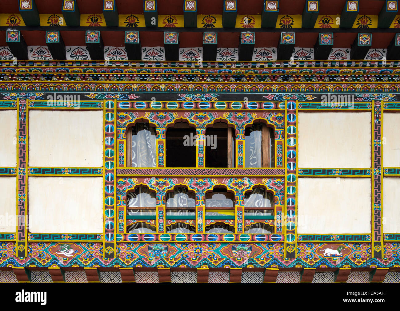 Colorful decorations on windows and doors, traditional Bhutanese architecture, Lobesa, Bhutan Stock Photo