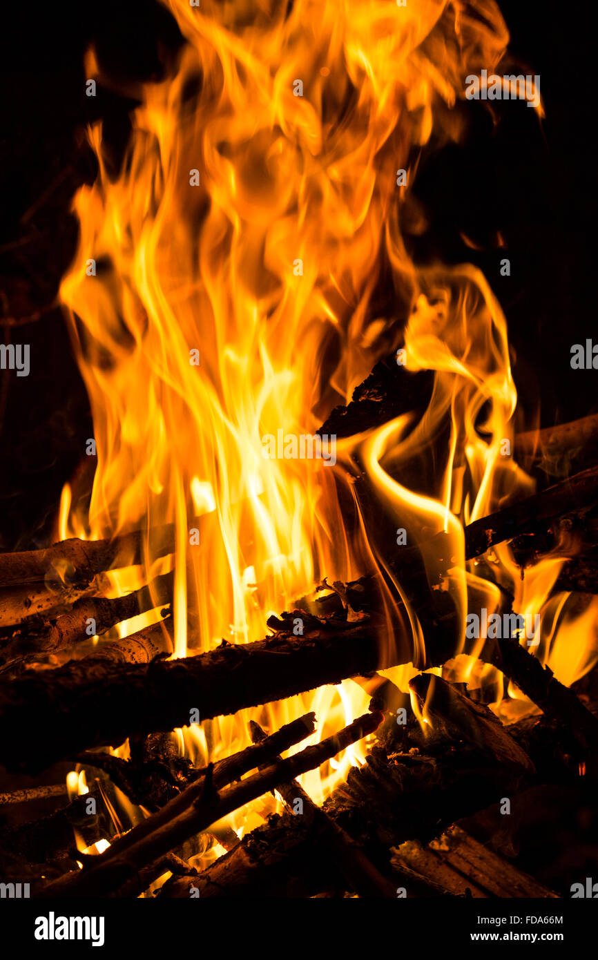 Closeup of flames of a wood fire with burning logs and branches Stock Photo