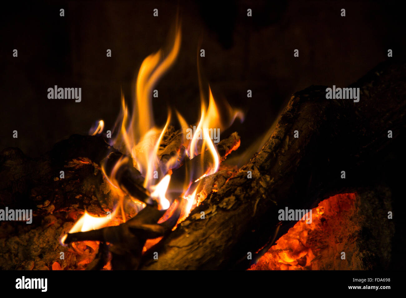 A small wood fire burning logs and branches Stock Photo