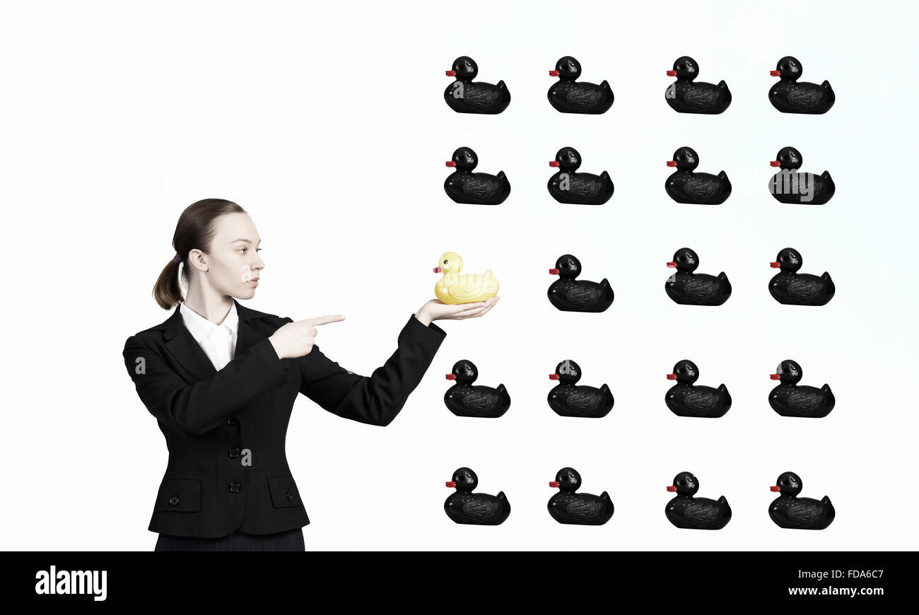 Young businesswoman holding yellow rubber duck toy in palm Stock Photo