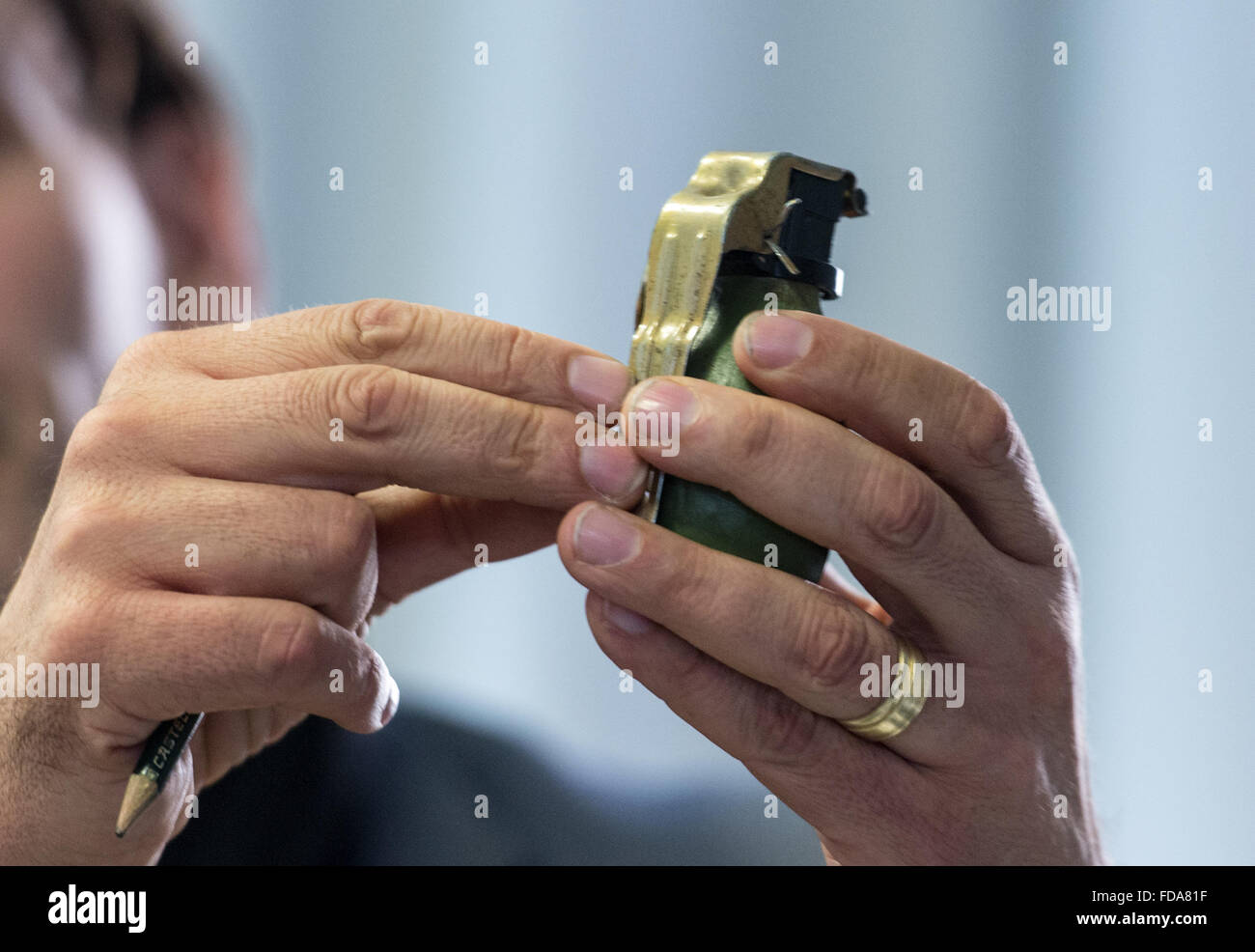 Villingen-Schwenningen, Germany. 29th Jan, 2016. Chief Director Andreas Stenger from the Baden-Wuerttemberg State Criminal Office shows a model of the M52 hand grenade from the former Yugoslavia during a press conference in Villingen-Schwenningen, Germany, 29 January 2016. An unknown assailant threw a grenade of this type over the fence of a refugee shelter. The granade however did not explode. Photo: PATRICK SEEGER/dpa/Alamy Live News Stock Photo