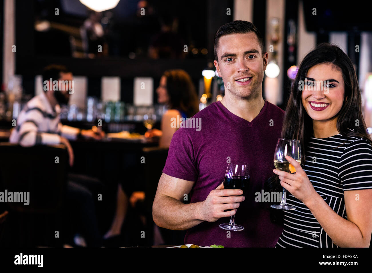 Portrait of couple having a glass of wine Stock Photo - Alamy