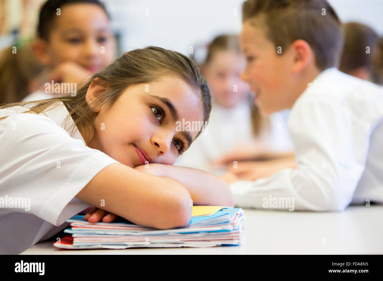 A close up shot of a little girl at school who looks distant and upset. Stock Photo