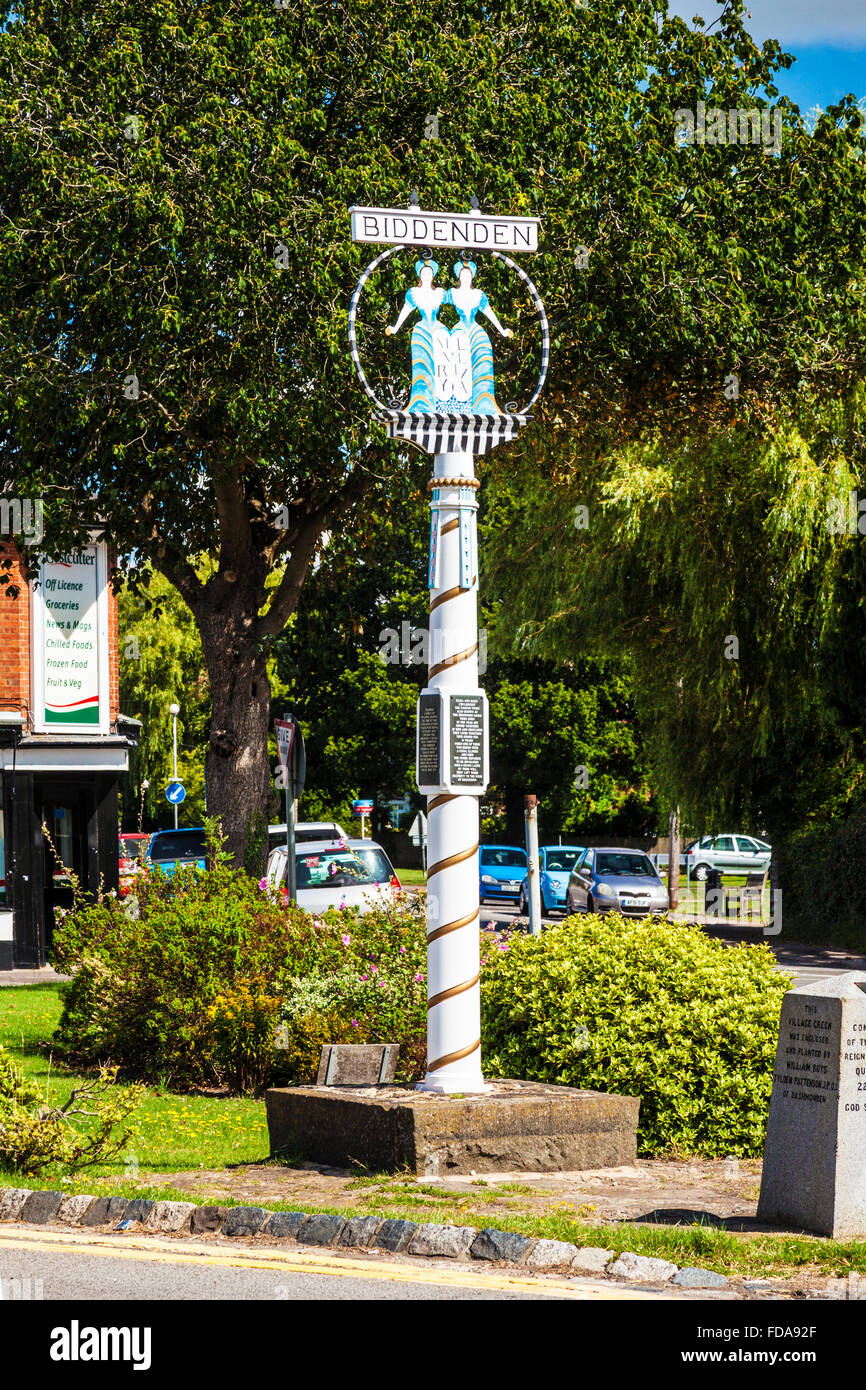 The village signpost telling the story of the Siamese twins know as the Biddenden Maids in the Kentish village of Biddenden. Stock Photo