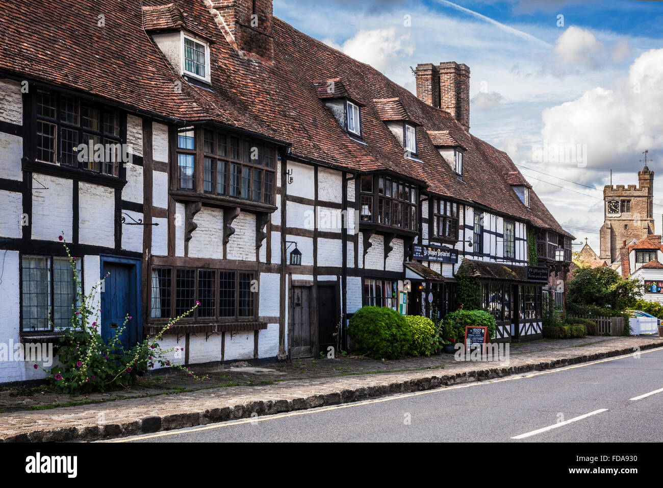All Saints church and Ye Mayedes restaurant in the pretty village of Biddenden in Kent. Stock Photo