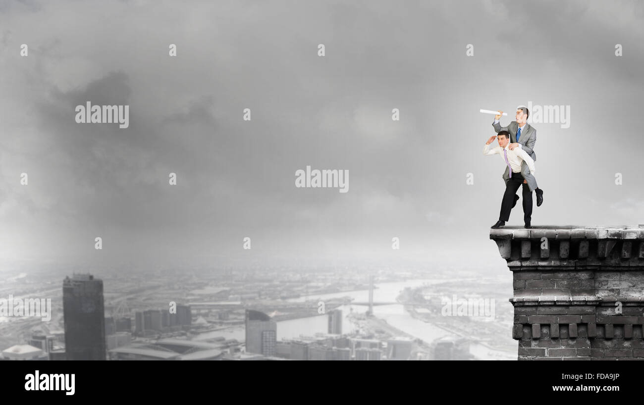 Businessman riding on back of his colleague Stock Photo - Alamy