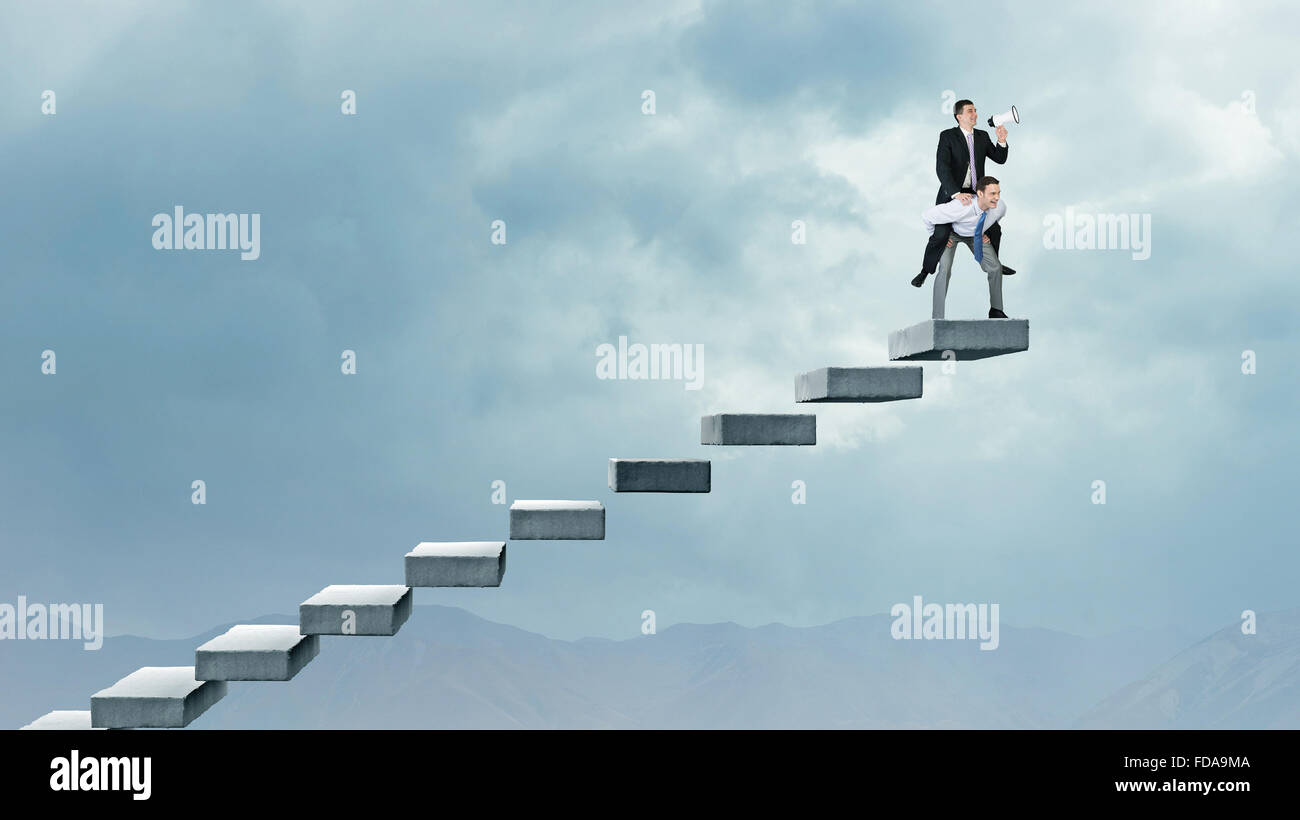 Businessman riding on back of his colleague Stock Photo - Alamy