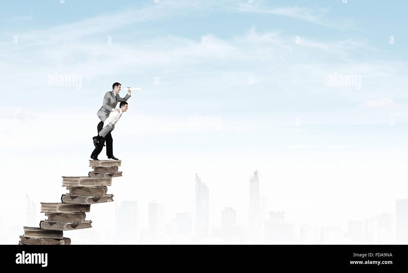 Businessman riding on back of his colleague Stock Photo - Alamy