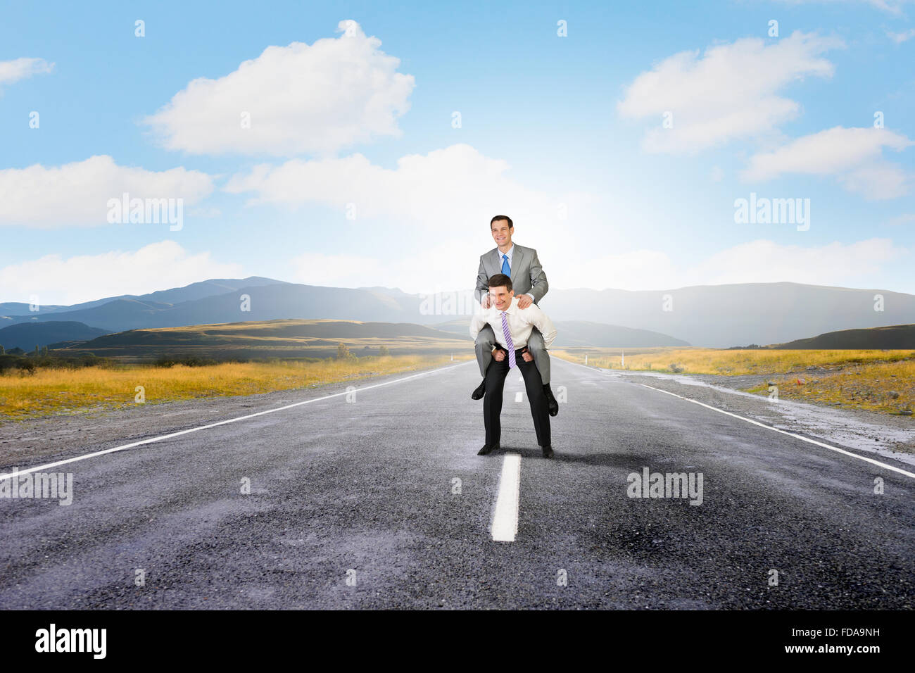 Businessman riding on back of his colleague Stock Photo - Alamy
