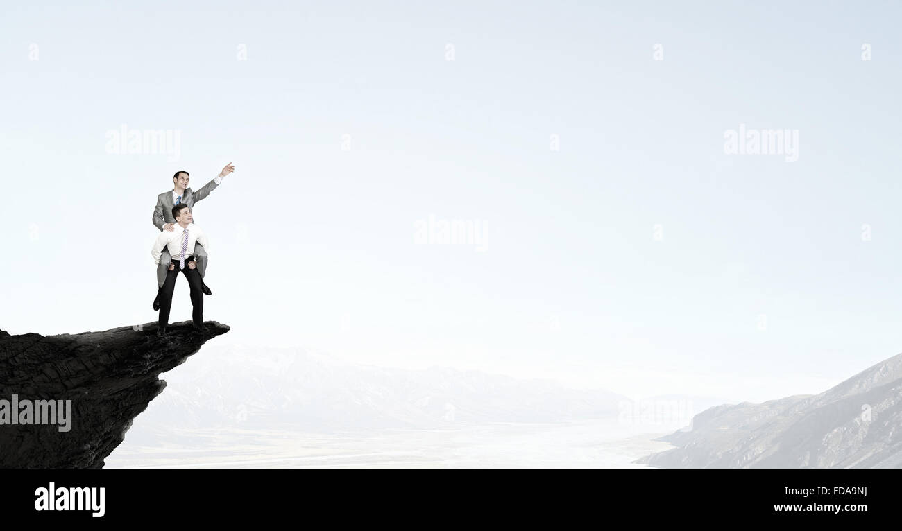 Businessman riding on back of his colleague Stock Photo - Alamy