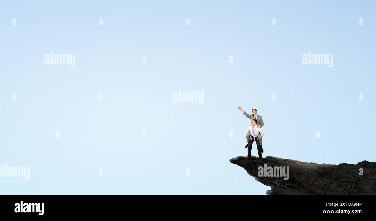 Businessman riding on back of his colleague Stock Photo - Alamy