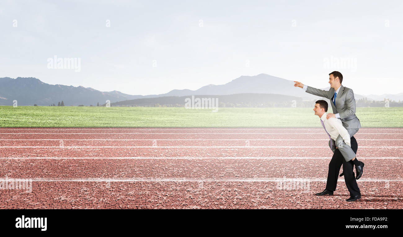 Businessman riding on back of his colleague Stock Photo - Alamy