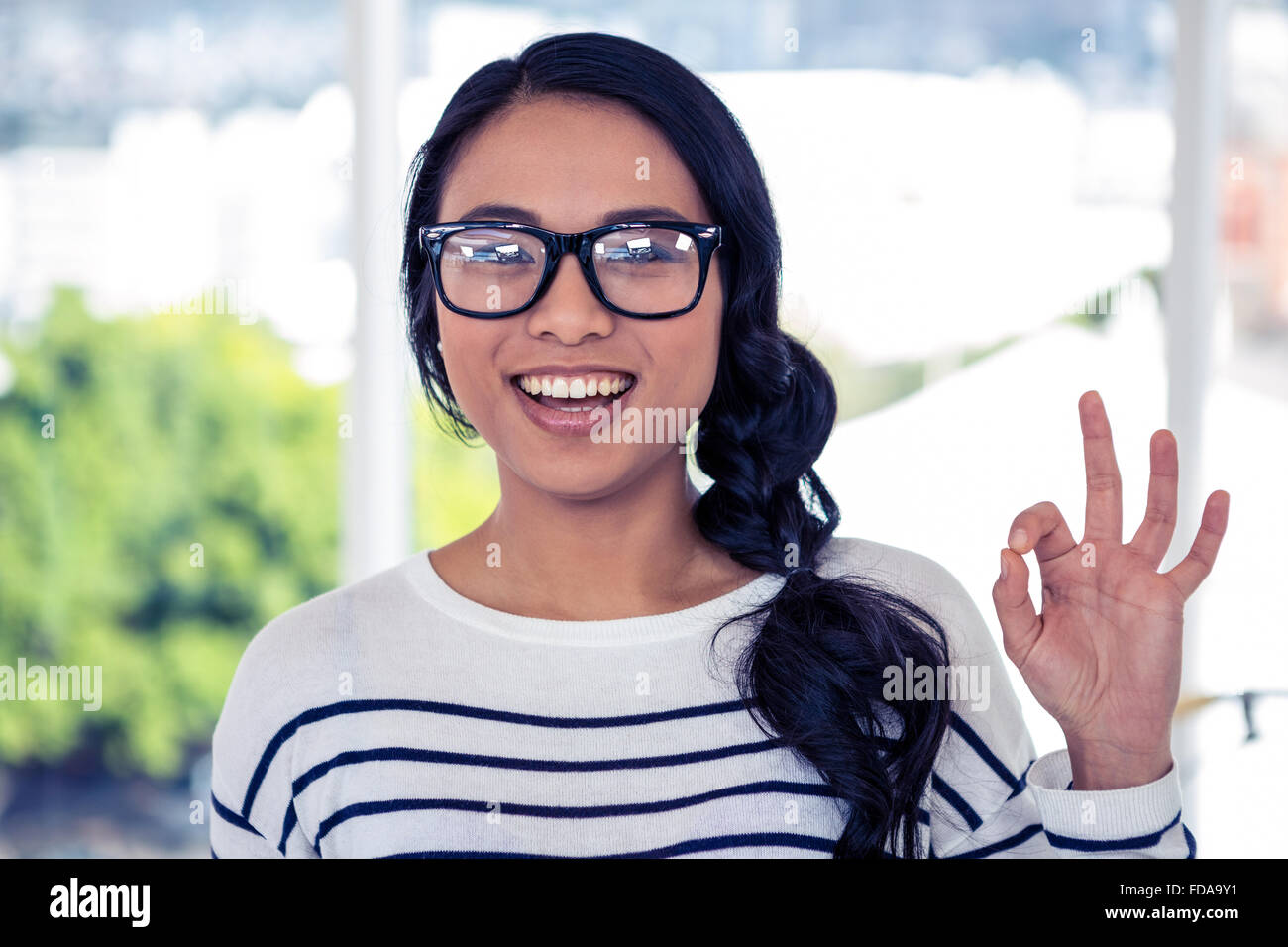 Smiling Asian woman making ok sign with hand Stock Photo - Alamy