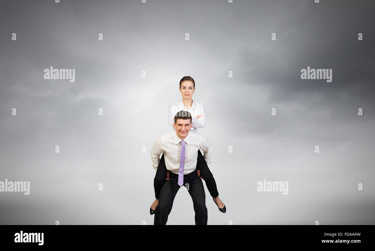 Businesswoman riding on back of her colleague Stock Photo - Alamy