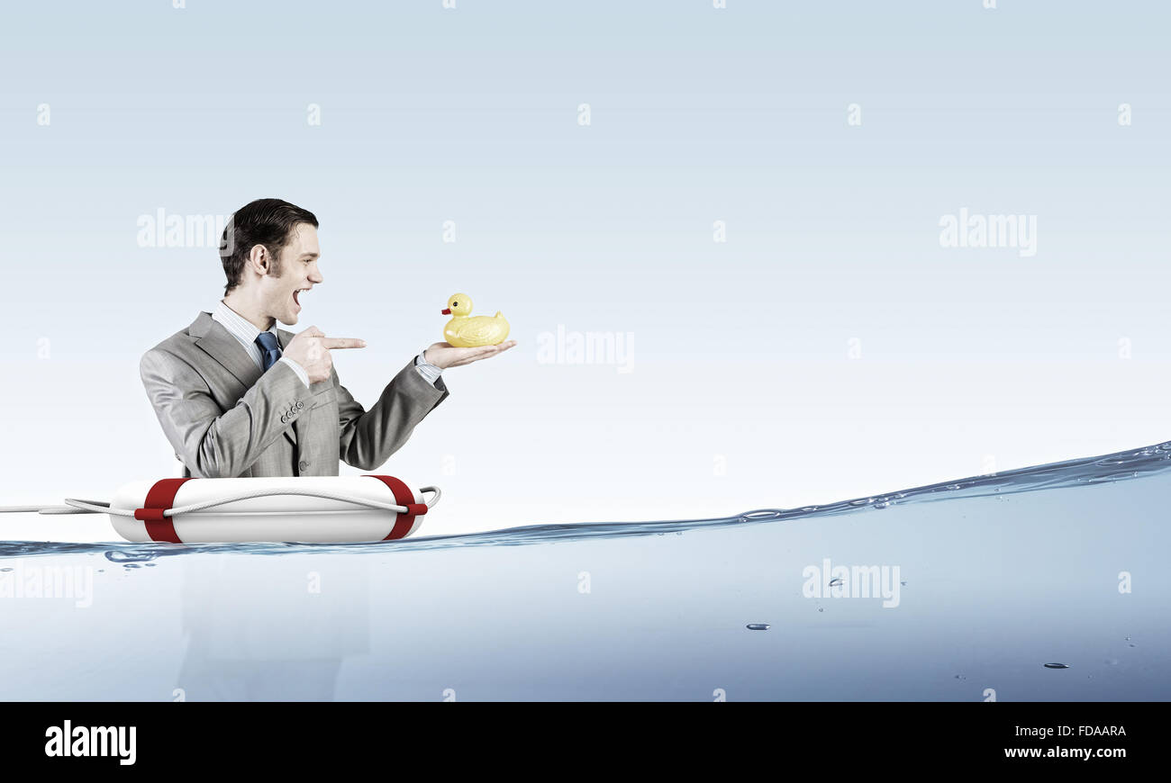 Funny businessman with yellow rubber duck toy Stock Photo